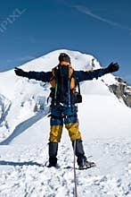Mountaineer embracing peak