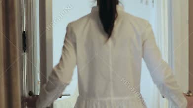 Girl opens beautiful classic door, enters the room