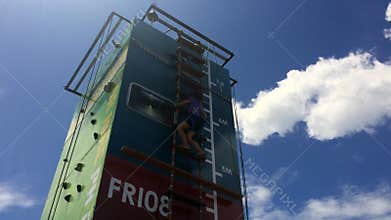 Girl climb on step ladder on a high vertical wall