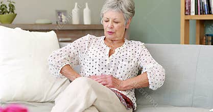 Senior woman suffering with a belly pain