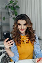 Lady using phone in a cafe
