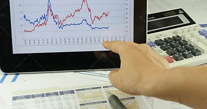 4k Businessman work on tablet with diagrams,finger touching finance pie charts.