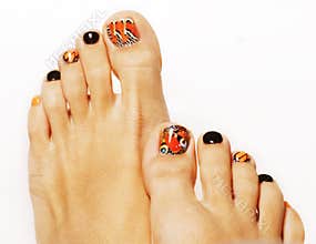 Bright butterfly design pedicure fingers isolated on white background close up