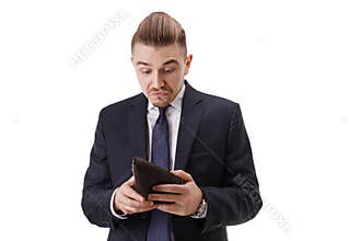 Handsome bussinessman with a good sense of humor hold his wallet and try to realize how much money he has inside.