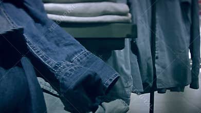 Shelves with denim clothes in the store