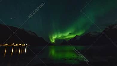 Polar lights (aurora borealis) in a fjord in Norway
