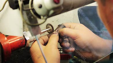 Brushed gold jewelry on a grinding wheel