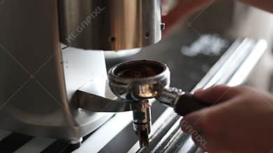 Barista grinds coffee slowmotion