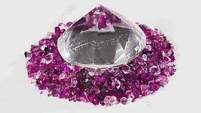 Huge diamond with many small gems stones rotating over white, loop ready