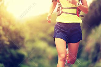 Fitness woman trail runner running on trail