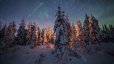 Aurora borealis over camp fire Lapland forest in Finland