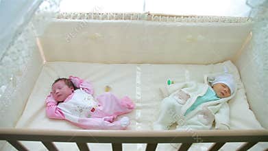 Two little baby sleeping in stroller
