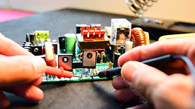 Repairing electronics board.