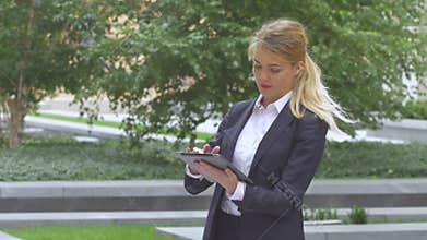 Woman with tablet computer near office building. close up