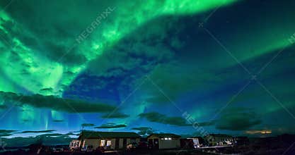 Aurora borealis (Northern Lights) above cabins