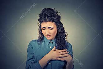Young woman with breast pain touching chest