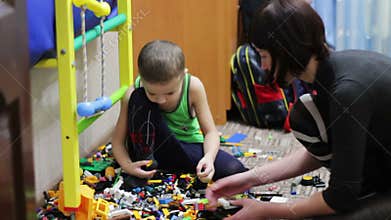 Child Boy and his Mother Playing with Toys