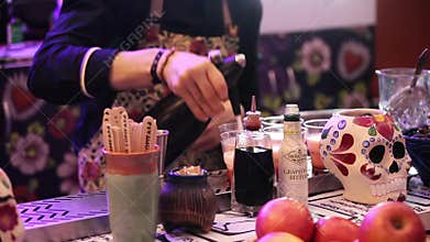 Barman making drinks in bar