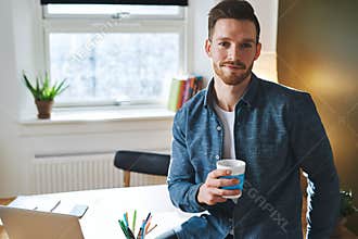 Young entrepreneur sitting in his office