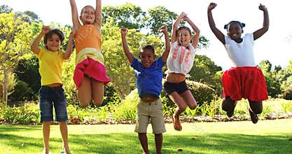 Group of kids jumping together in park