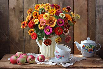 Still-life with a bouquet of garden flowers and tea utensils.
