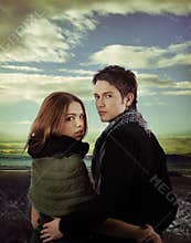 Attractive couple in nature against dramatic sky