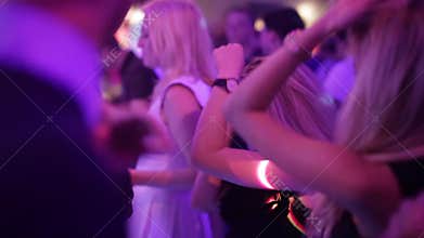 Girl dancing in a club, in a crowd of people