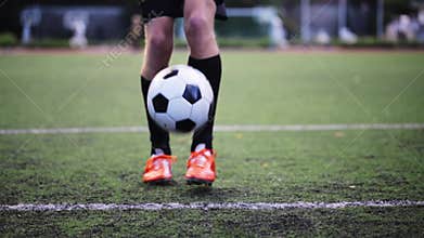 Soccer player playing with ball on field