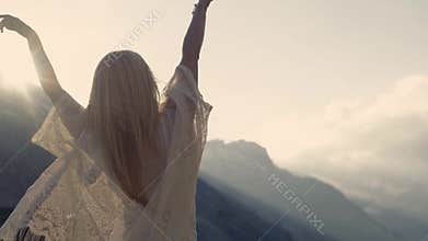 Girl is dancing, bright sunshine and amazing nature around.