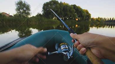 Fishing on a lake from rubber boat. first-person view