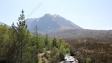 Ben Nevis Scotland UK snow topped mountain in summer with mountain stream in foreground, Lochaber Scottish Highlands