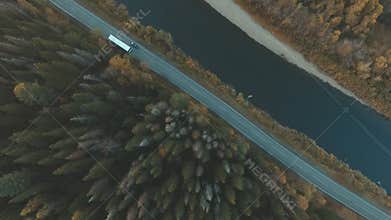 Aerial of nature. River parallel to the road. Tree crown.