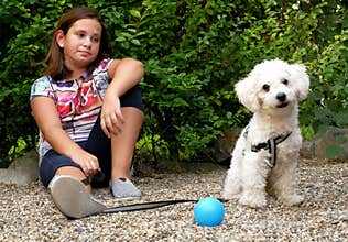 Girl and her dog in the garden