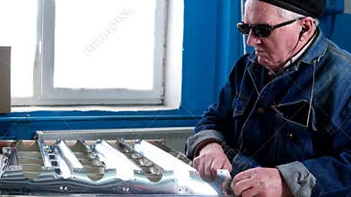 Blind man in the dark glasses at work