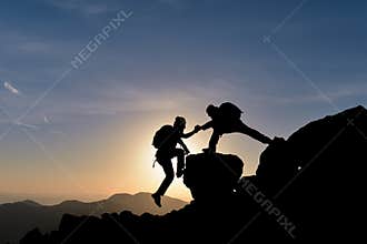 Rock climber helping another