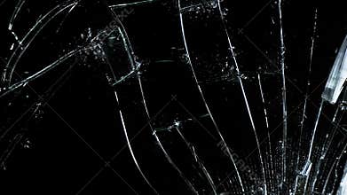Hammer breaking Pane of Glass against Black Background