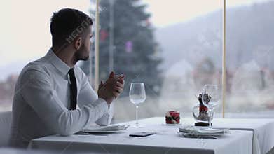 Handsome man with mobile phone in restaurant