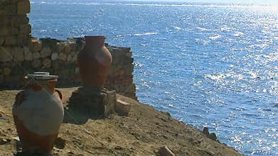 Calm ocean with blue sky and amphora .