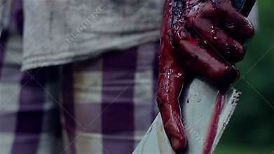 Monster holding a knife dripping blood