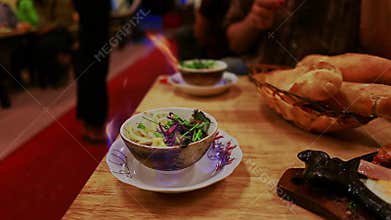 Plates with Burning Local Food Beverages Rolls Stand on Table