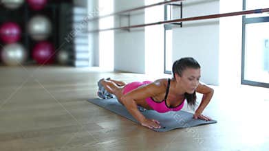 Brunette woman at gym push up push-up workout exercise