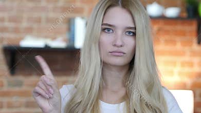 No, Not allowing Gesture by Waving Finger By Young Girl