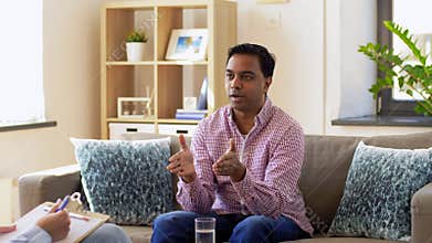 Man and psychologist at psychotherapy session