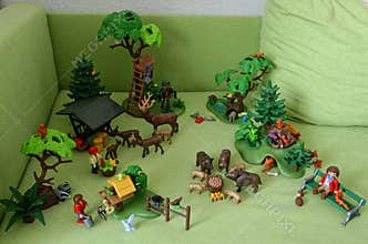 Playmobil toys of woodland animals arranged on green sofa
