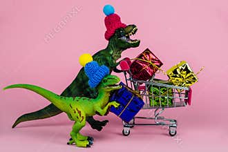 cute dinosaurs in knitted hats with shopping trolley full of present boxes, sale concept