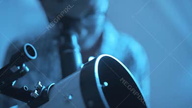 Smart boy using a telescope and learning astronomy