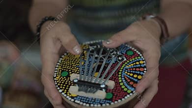 Woman`s hands play colorful kalimba. Bali, Indonesia.