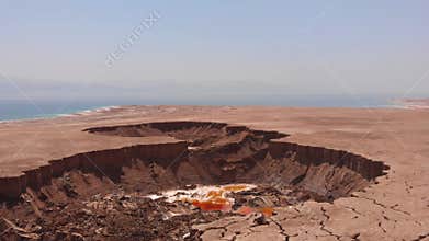 Drone flying over sinkholes in dead sea Israel,Jordan