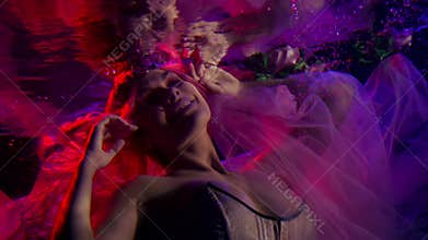 Fairy tale princess is diving under water, magic concept, smiling woman in deep
