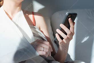 Wounded arm in bondage, woman rests in  bed, body parts.